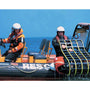 Load image into Gallery viewer, Two rescuers on a boat using Jason&#39;s Cradle man-overboard recovery system for safe victim recovery at sea.
