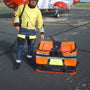 Load image into Gallery viewer, Helicopter load bag beside a person in safety gear, ready for offshore equipment transport.
